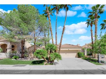 Charming single-story home with well-manicured front yard, lush greenery, and a two-car garage, offering great curb appeal at 1848 Indian Bend Dr, Henderson, NV 89074