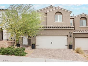 Charming two-story home with a well-manicured lawn, inviting entrance, and a two-car garage at 376 Yellow Finch Ln, Henderson, NV 89012
