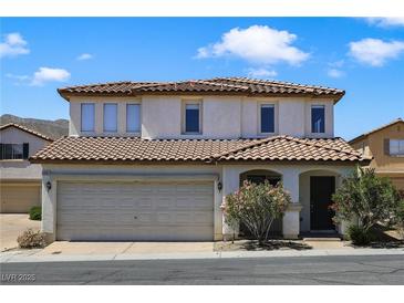 Charming two-story home featuring a well-maintained front yard, attached garage, and appealing architectural details at 3961 Bayamon St, Las Vegas, NV 89129