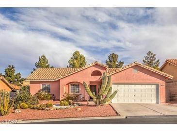 Charming single-story home with a desert landscape, barrel tile roof, and a two car garage at 7140 Pascal Dr, Las Vegas, NV 89156