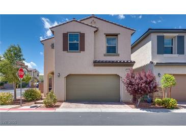 Two-story home featuring a two-car garage, neutral stucco, and low-maintenance landscaping at 7559 Chimney Point Ct, Las Vegas, NV 89166