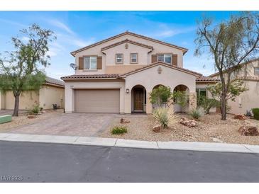 Charming two-story home featuring a well-manicured front yard with desert landscaping and a two car garage at 7878 Brianna Cheerful Ave, Las Vegas, NV 89178