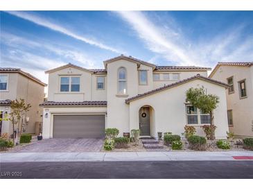 Beautiful two-story home with a neutral color scheme, arched entry, and attached two-car garage at 8171 California Pine St, Las Vegas, NV 89166
