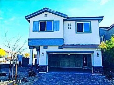 Charming two-story home featuring a two-car garage, covered porch, and stone accents at 95 Palm Park Ct, Las Vegas, NV 89183