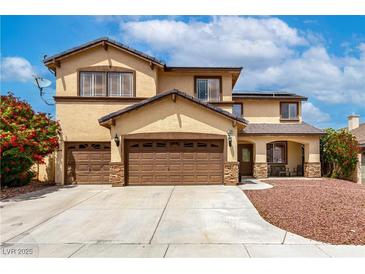 Inviting two-story home featuring a three-car garage, well manicured landscaping and covered porch at 9604 Windom Point Ave, Las Vegas, NV 89129