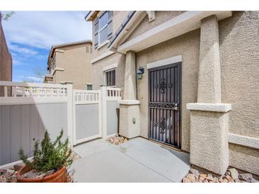 A close up of a home's front entrance with a security door and small courtyard with planter at 961 Wembly Hills Pl, Henderson, NV 89011