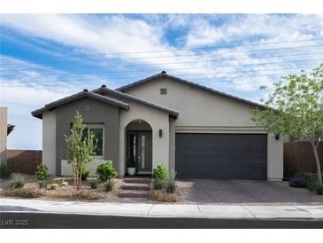 Charming single-story home with a modern design, desert landscaping, and an attached two-car garage at 11813 Pippa Ave, Las Vegas, NV 89138