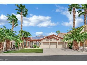 Charming home featuring desert landscaping, three-car garage, and solar panels at 1324 European Dr, Henderson, NV 89052
