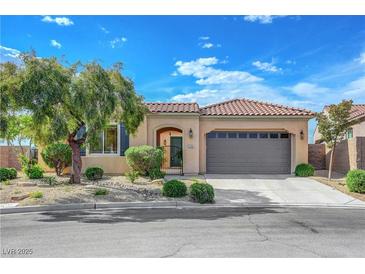 Charming single-story home features a well-manicured front yard with desert landscaping and a two-car garage at 2764 Leys Burnett Ave, Henderson, NV 89044