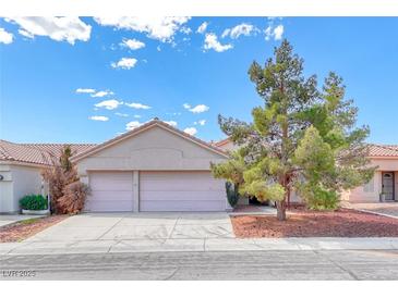 Charming single-story home with a two-car garage, well-maintained landscaping, and beautiful curb appeal at 3413 Freestone Ln, North Las Vegas, NV 89032