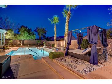Luxurious backyard pool with spa, desert landscaping, and covered lounge area perfect for relaxation at 4624 Leon De Oro Dr, Las Vegas, NV 89129