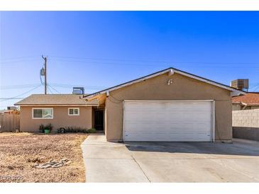 Single story home with a two-car garage and low maintenance xeriscape front yard at 5813 Halifax Ave, Las Vegas, NV 89107