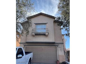 Charming two-story home featuring a balcony and an attached two-car garage at 7011 Azure Beach St, Las Vegas, NV 89148