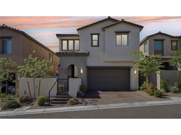 Charming two-story home boasts a neutral color scheme, a well-maintained front yard, and a two-car garage at 12053 Arrebol Ave, Las Vegas, NV 89138