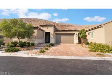Charming single-story home with a well-manicured front yard and a brick driveway leading to a two-car garage at 12843 New Providence St, Las Vegas, NV 89141