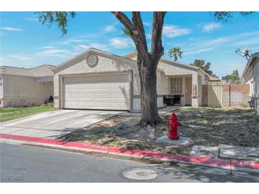 Charming single-story home featuring a well-maintained front yard and attached two-car garage at 1911 Winter Hill St, Las Vegas, NV 89106