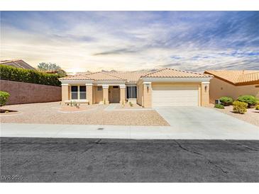 Charming single-story home featuring a two-car garage, desert landscaping, and a tile roof at 2205 Beacon Ridge Dr, Las Vegas, NV 89134