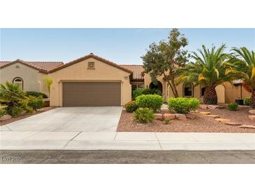 Charming single-story home with desert landscaping, a tile roof and a two-car garage at 2357 Aztec Ruin Way, Henderson, NV 89044