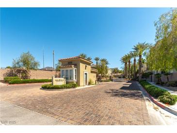 Community entrance featuring a guardhouse and lush landscaping, providing security and curb appeal at 2555 Hampton Rd # 2308, Henderson, NV 89052