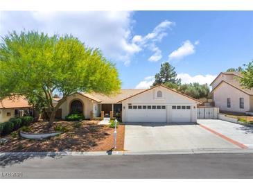 Charming single-story home with a well-manicured front yard, large shade tree, and three-car garage at 3221 Palmdesert Way, Las Vegas, NV 89120