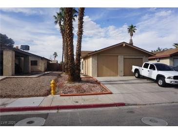Charming single-story home with a two-car garage, a driveway and desert landscaping at 4498 Via San Rafael, Las Vegas, NV 89103