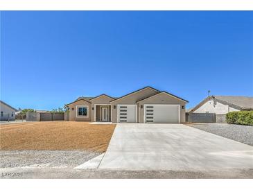 Charming single story home featuring a three-car garage and low-maintenance landscaping with plenty of parking space at 5251 Graystone, Pahrump, NV 89061