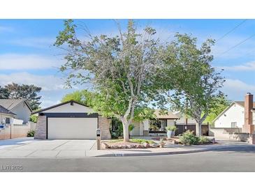 Charming single-story home featuring a two-car garage and mature landscaping with shade trees at 5772 Arbor Oak Cir, Las Vegas, NV 89142