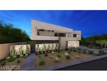 Contemporary home featuring desert landscaping, a decorative stone wall and modern architectural design at 607 Grand Rim Dr, Henderson, NV 89012