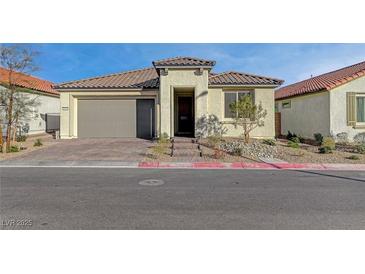 Charming single-story home with a well-maintained front yard and an attached two-car garage at 6544 Sandero Springs St, Las Vegas, NV 89166