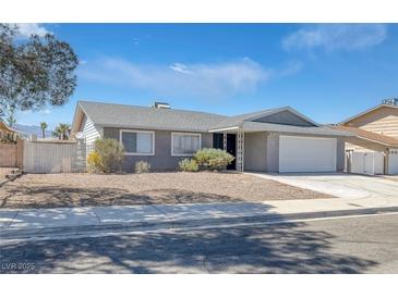 Charming single-story home with a well-maintained front yard and an attached two-car garage at 720 Sam Jonas Dr, Las Vegas, NV 89145