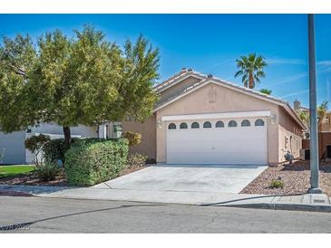 Charming single-story home with a well-maintained lawn, mature trees, and a two-car garage at 7572 Hope Valley St, Las Vegas, NV 89139