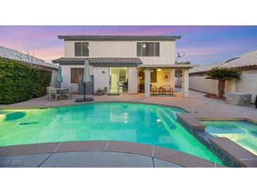Inviting backyard showcases a refreshing pool and spa, complemented by a covered patio area perfect for entertaining at 781 Wigan Pier Dr, Henderson, NV 89002