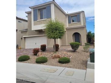 Two-story home featuring desert landscaping, muted exterior color scheme, attached two car garage, and blue shuttered windows at 9020 Tiffany Oaks Ave, Las Vegas, NV 89148