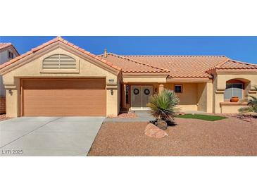 Charming single-story home showcasing a desert landscape, a terracotta roof, and double-door entrance at 9912 Woodhouse Dr, Las Vegas, NV 89134
