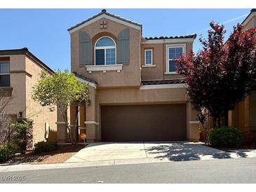Two-story home featuring a well maintained yard, a two car garage, and charming architectural details at 10271 Headrick Dr, Las Vegas, NV 89166