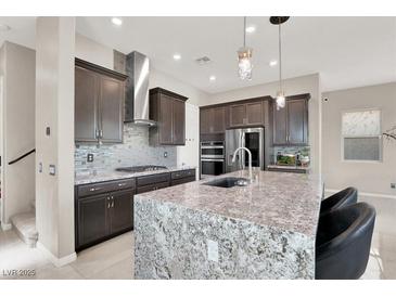 A modern kitchen with granite countertops, stainless steel appliances, and a stylish backsplash at 12426 Oregon Cherry Ave, Las Vegas, NV 89138