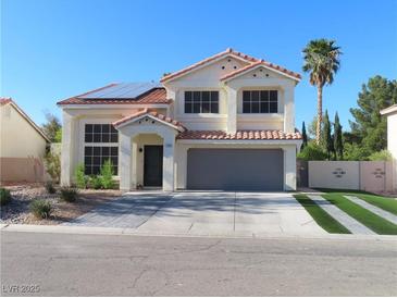Charming two-story home features desert landscaping, a red tile roof, and solar panels at 1508 Silver Knoll Ave, Las Vegas, NV 89123