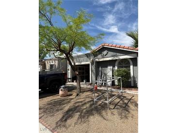Single-story home featuring a stucco exterior, an attached garage, and a low-maintenance yard at 2377 Los Feliz St, Las Vegas, NV 89156