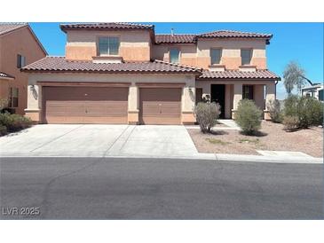 Two-story home featuring a three-car garage, neutral color palette, and well-maintained landscaping at 2539 Early Light Dr, Las Vegas, NV 89142