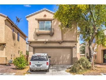 Two-story home featuring a tan exterior, a two-car garage, and a small landscaped front yard at 3568 Gloucester Gate St, Las Vegas, NV 89122