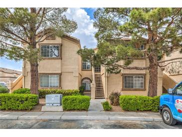Inviting condo building with manicured landscaping and exterior stairs to upper units at 3660 Renovah St # 202, Las Vegas, NV 89129