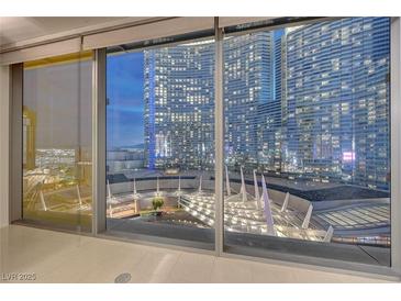 Modern living room showcasing stunning city views through expansive floor-to-ceiling windows at 3726 S Las Vegas Blvd # 1003, Las Vegas, NV 89158