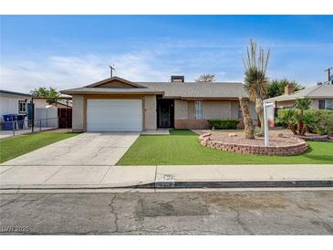 Charming single-story home with a well-maintained front yard and a driveway leading to a single car garage at 4428 Ash Ave, Las Vegas, NV 89110