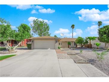 Charming single-story home with a well-maintained front yard, desert landscaping, and a two-car garage at 6408 Shawnee Pl, Las Vegas, NV 89107
