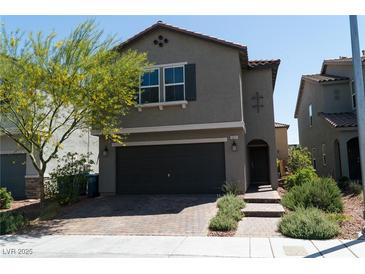 Charming two-story home features a front yard with desert landscaping and an attached two-car garage at 6631 Frosted Harvest Ave, Las Vegas, NV 89108