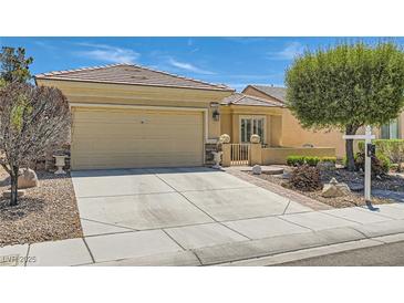 Charming single-story home with a well-manicured lawn and a two-car garage at 7720 Fruit Dove St, North Las Vegas, NV 89084
