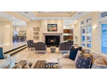 Elegant living room featuring a fireplace, tile flooring, and stylish furnishings at 1234 Campbell Dr, Las Vegas, NV 89102