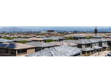 View of new neighborhood featuring tile roofs and beautiful city skyline in the background at 12524 Skylight View St, Las Vegas, NV 89138