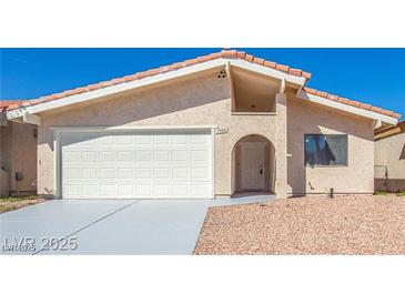 Inviting single-story home with a well-maintained front yard and two-car garage at 1900 Cameron St, Las Vegas, NV 89102