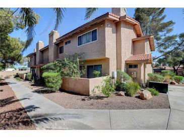 Charming townhome featuring a red tile roof, low-maintenance landscaping, and a cozy front patio at 3380 Pavlo St, Las Vegas, NV 89121
